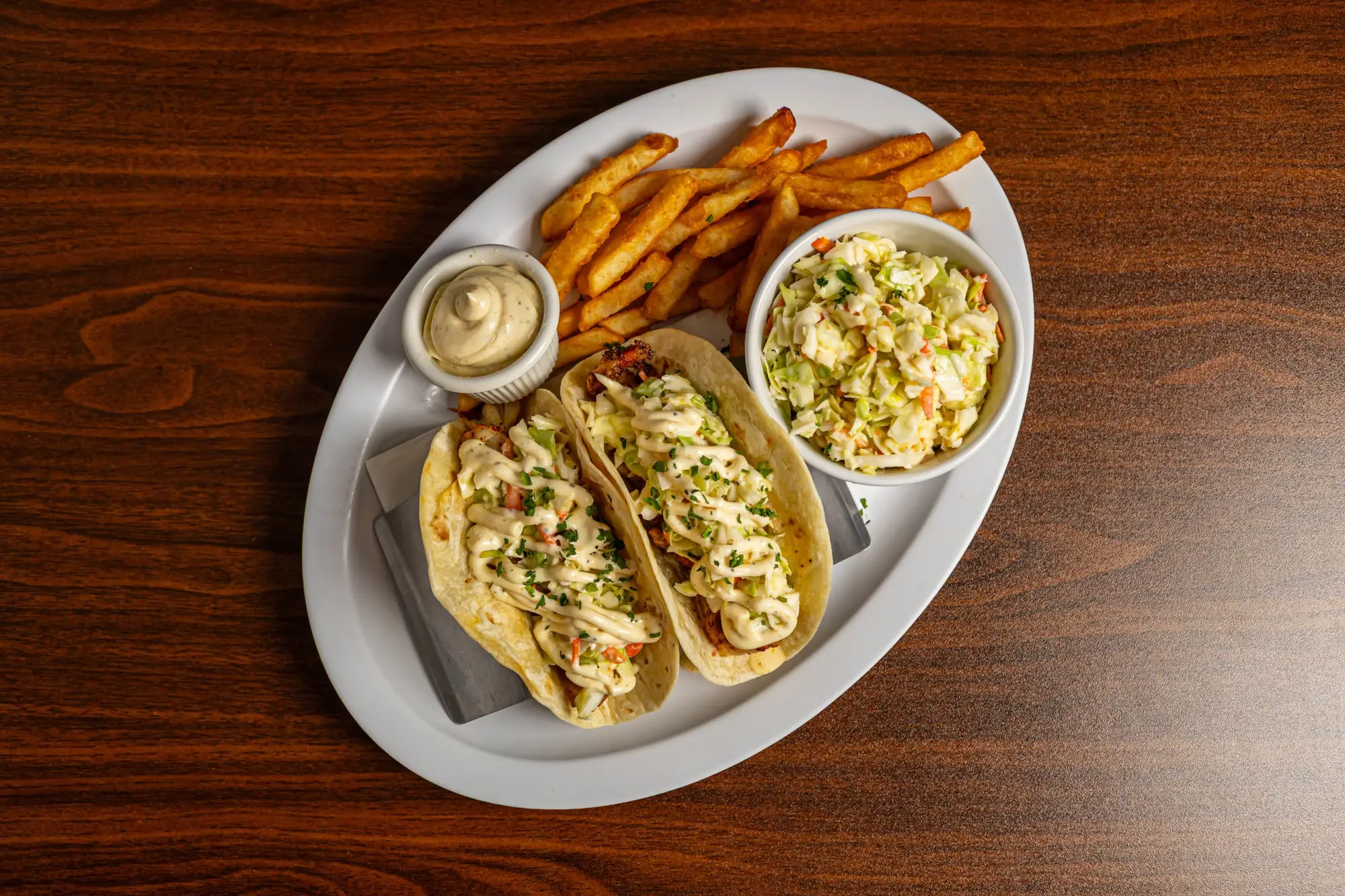 Doug's Seafood grouper tacos with fries, coleslaw and dipping sauce