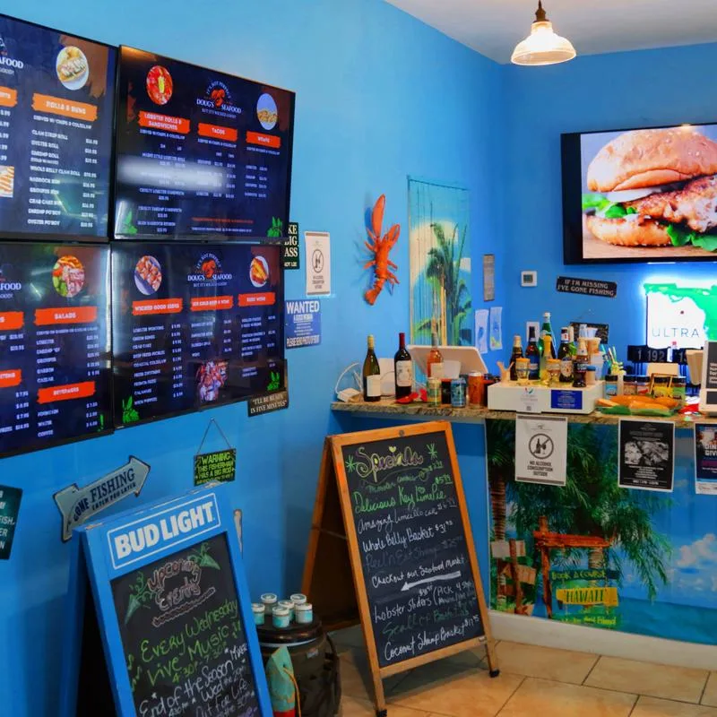 Beach-themed interior of Doug's Seafood with chalkboard menus
